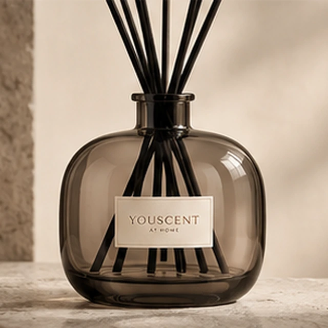 The Smoke reed diffuser, smoked glass. soft, rounded curves. Label saying Elizabeth.